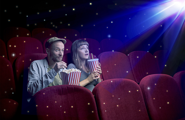 Lovely couple watching 3D movie with little sparkling stars around